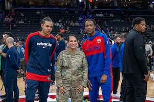 Two men and a woman pose for a photo