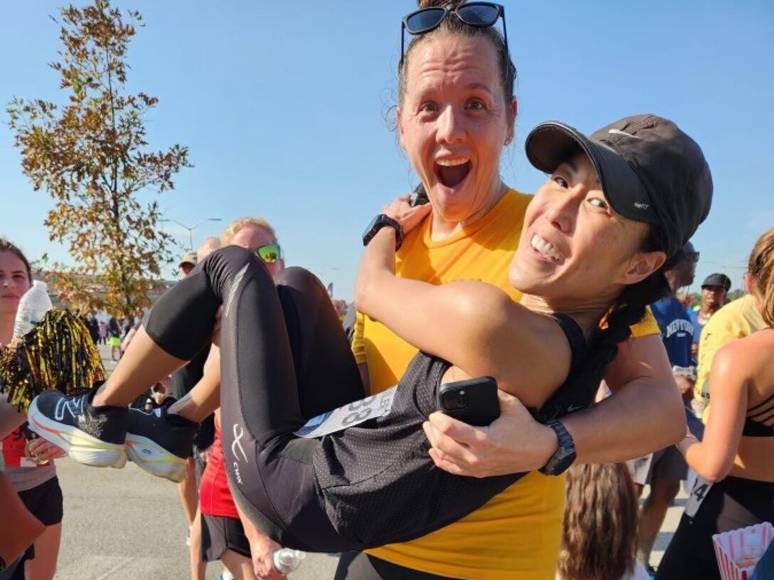 Capt. Stefanie Faull lifts Col. Jeanine Huh, who she refers to as the amputator,  at this year’s Army Ten Miler.