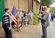 Civilian Aide to the Secretary of the Army, Mr Mark Benton, reading the Army Officer Oath of Office Captain Sonja Chestnut.