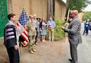 Civilian Aide to the Secretary of the Army, Mr Mark Benton, reading the Army Officer Oath of Office Captain Sonja Chestnut.