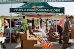 Volunteers work at drive-thru food distribution event