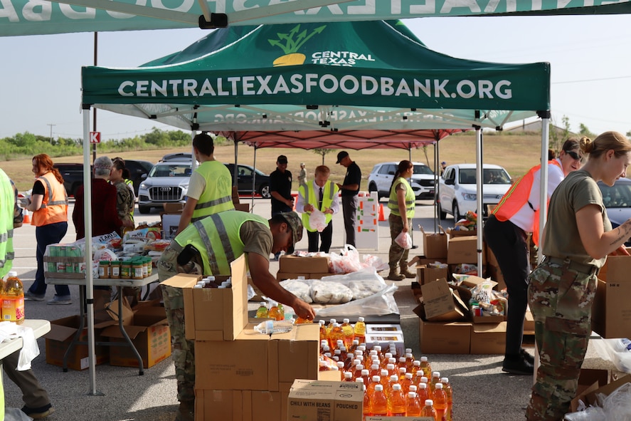 Volunteers work at drive-thru food distribution event