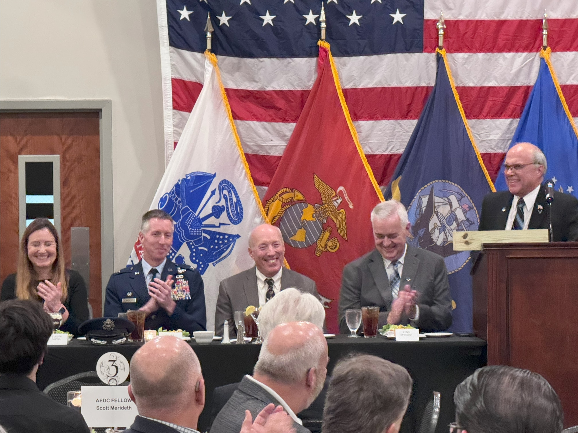 Attendees offer a round of applause during the Arnold Community Council annual banquet Nov. 14, 2024. Attendees heard from several speakers, and the ACC inducted three new Arnold Engineering Development Complex Fellows during the event. Those inducted were Alan Hale, Scott Meredith and Gary Knox. Pictured from left are Evelyn Mizell, AEDC Commander Col. Grant Mizell, Air Force Test Center Executive Director Arthur Huber, incoming ACC President and Tullahoma Mayor Lynn Sebourn, and outgoing ACC president retired Air Force Col. Dan Pierre. (Courtesy photo)