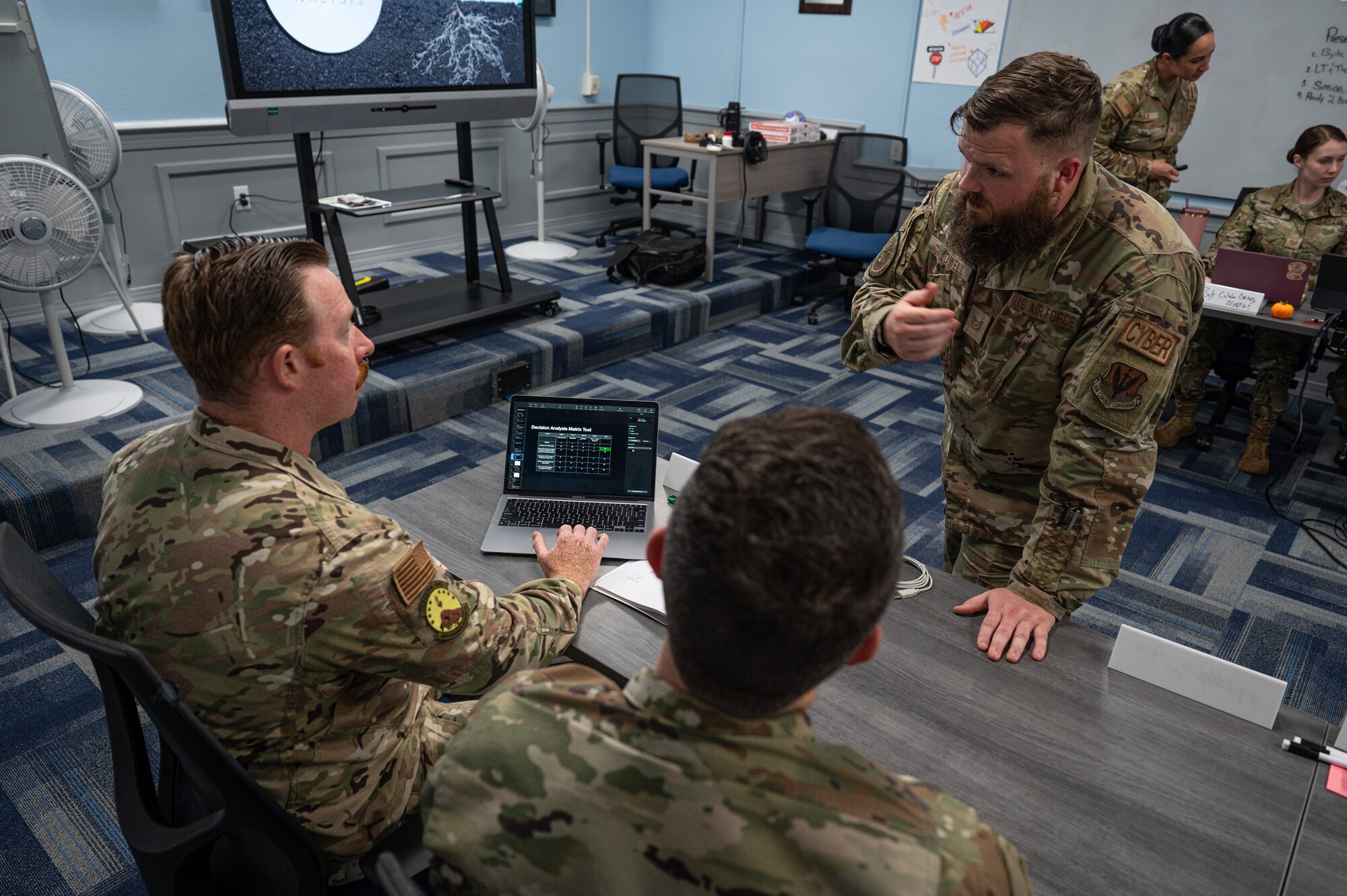 Airmen discuss information for their presentation