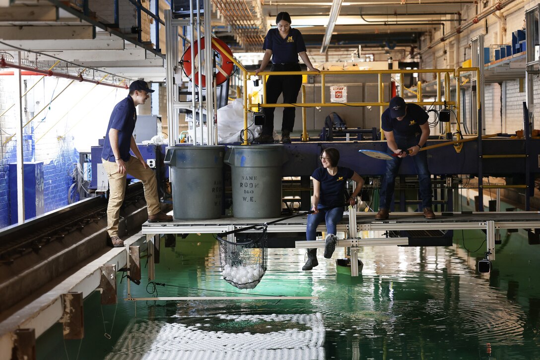 University of Michigan students retrieve whiffle balls from the university’s tow tank after a day of testing on Feb. 2, 2023.