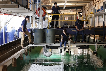 University of Michigan students retrieve whiffle balls from the university’s tow tank after a day of testing on Feb. 2, 2023.