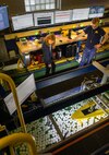 Arianna Kerkmaz and Patrick White, students at the University of Michigan, observe a model of a guided-missile destroyer during testing on Dec. 12, 2023, in the university’s tow tank
