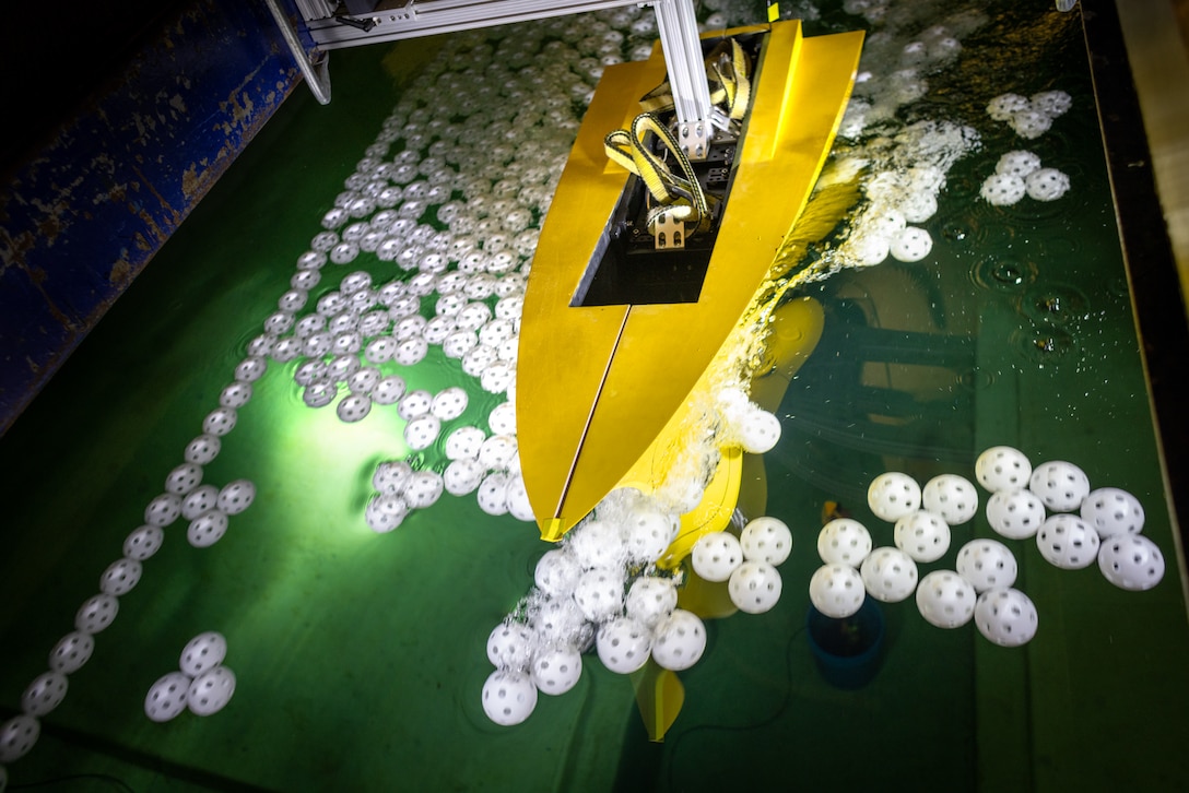 A segmented model of a guided-missile destroyer undergoes testing in the University of Michigan’s tow tank to measure forces on different parts of the hull and the sonar dome.