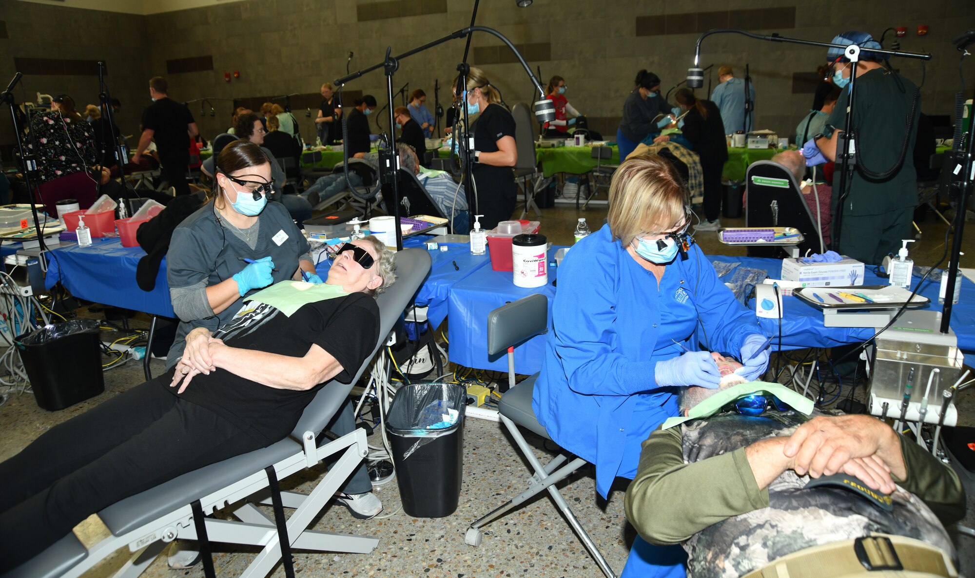 two people laying in chairs getting their teeth cleaned