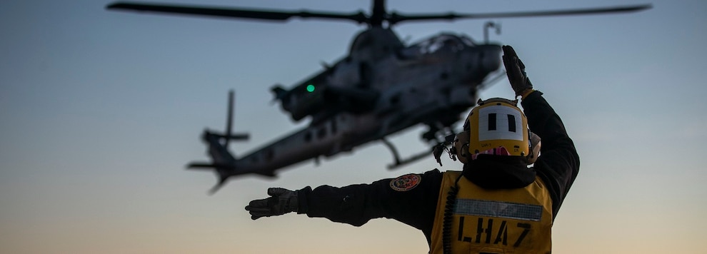 Sailors guides an AH-1Z Viper helicopter assigned to Marine Light Attack Helicopter Squadron (HMLA) 169 lands on the flight deck aboard amphibious assault carrier USS Tripoli (LHA 7), Nov. 19, 2024.