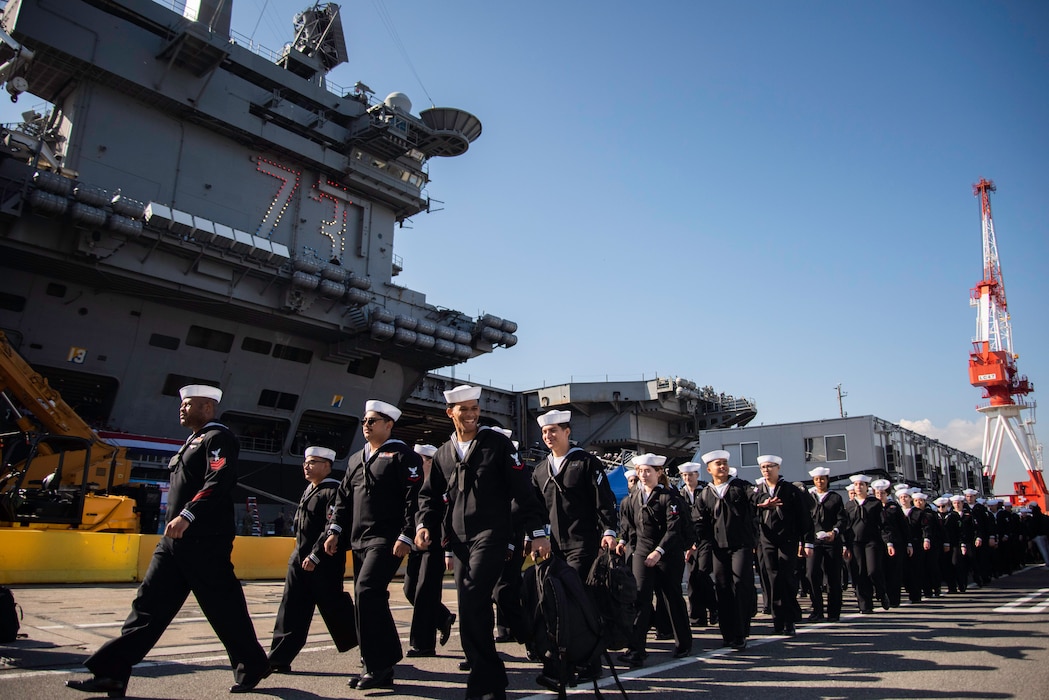 Sailors disembark USS George Washington (CVN 73) during a homecoming celebration at Fleet Activities Yokosuka.