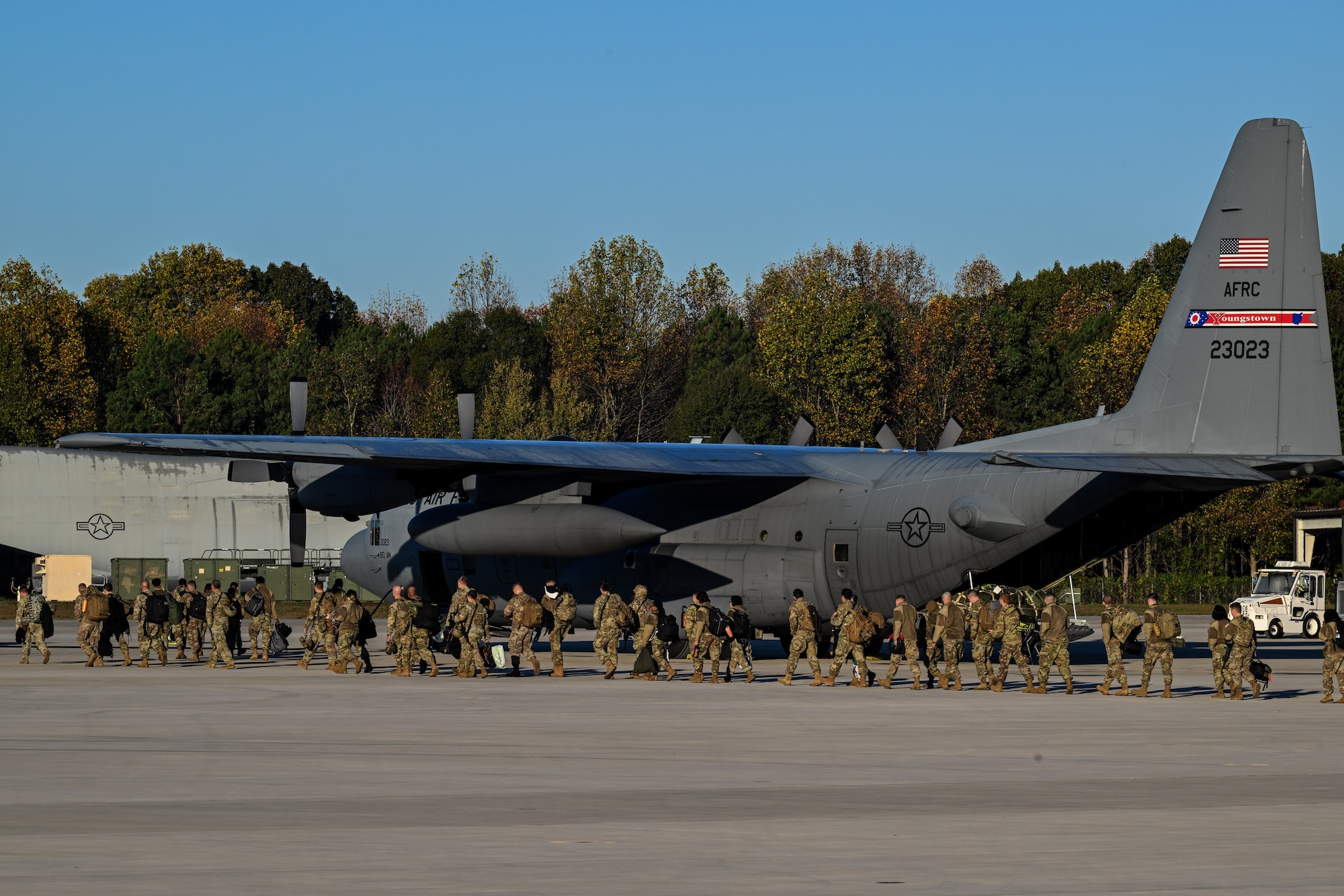 Citizen Airmen assigned to the 910th Airlift Wing walk toward a C-130H Hercules to travel back to Ohio on the flightline at Dobbins Air Reserve Base, Georgia, Nov. 16, 2024.