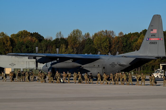 Citizen Airmen assigned to the 910th Airlift Wing walk toward a C-130H Hercules to travel back to Ohio on the flightline at Dobbins Air Reserve Base, Georgia, Nov. 16, 2024.