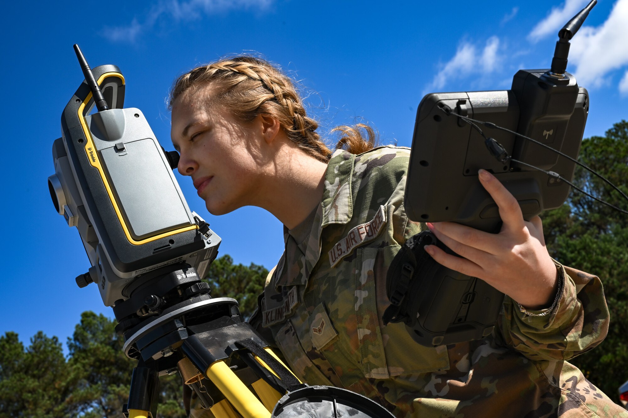 A Citizen Airman assigned to the 910th Civil Engineer Squadron looks through surveying equipment to evaluate the elevation of the practice flightline at Dobbins Air Reserve Base, Georgia, Nov. 15, 2024.