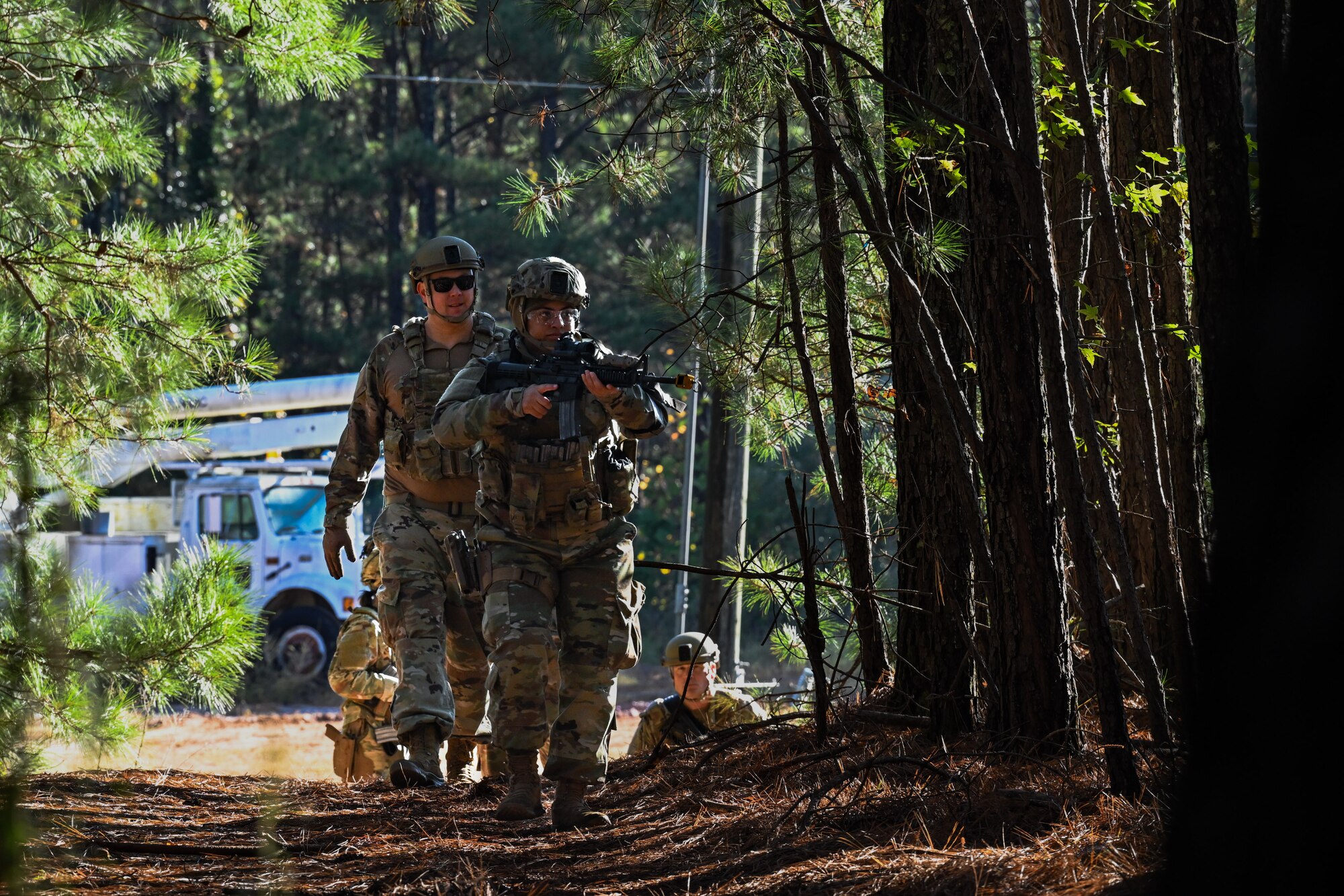 Citizen Airmen assigned to the 910th Security Forces Squadron walk into wooded terrain during a SF exercise at Dobbins Air Reserve Base, Georgia, Nov. 15, 2024.