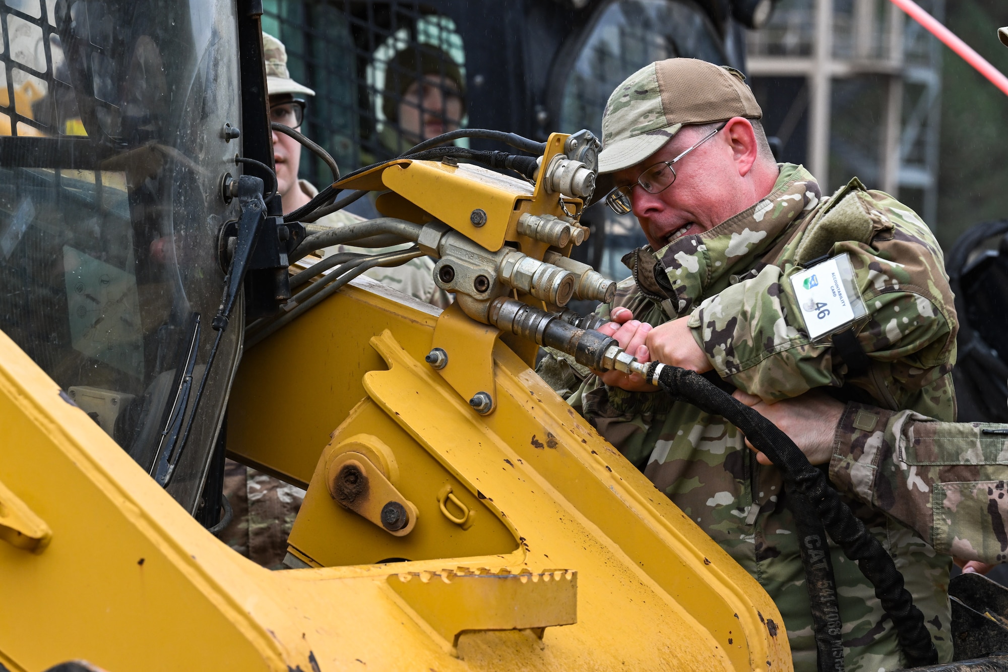 A Citizen Airman assigned to the 910th Civil Engineer Squadron connects a hydraulic line on a skid steer loader at Dobbins Air Reserve Base, Georgia, Nov. 14, 2024.