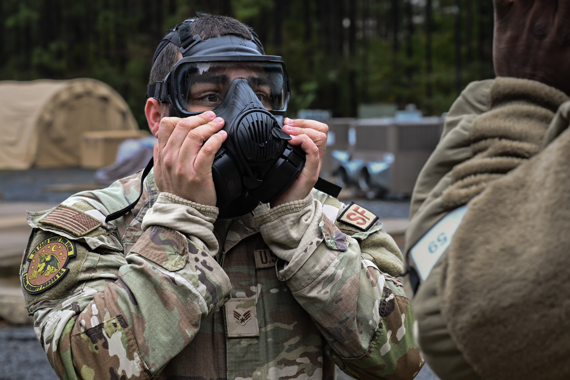 A Citizen Airman assigned to the 910th Security Forces Squadron adjusts their gas mask during a Chemical, Biological, Radiological, Nuclear and high-yield Explosives class at Dobbins Air Reserve Base, Georgia, Nov. 14, 2024.
