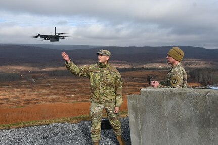 Staff Sgt. Luis Andujar, left, prepares to catch a drone piloted by Sgt. 1st Class Richard Hutnik, right, Nov. 15, 2024, at Fort Indiantown Gap, Pa. Andujar and Hutnik, both with 1st Battalion, 166th Regiment - Regional Training Institute were using drones to collect targeting data that was used to submit a call for fire to instructors and students with 2nd Battalion, who engaged the targets with artillery fire using M119, M777, and M109A6 howitzers. (Pennsylvania National Guard photo by Brad Rhen)