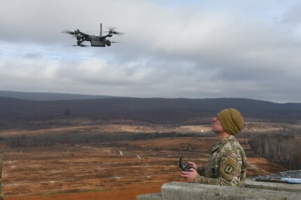 Sgt. 1st Class Richard Hutnik, quality assurance noncommissioned officer for the 166th Regiment – Regional Training Institute’s 1st Battalion, uses a drone to acquire targeting data Nov. 15, 2024, at Fort Indiantown Gap, Pa. This data was used to submit a call for fire to instructors and students with 2nd Battalion, who engaged the targets with artillery fire using M119, M777, and M109A6 howitzers. (Pennsylvania National Guard photo by Brad Rhen)