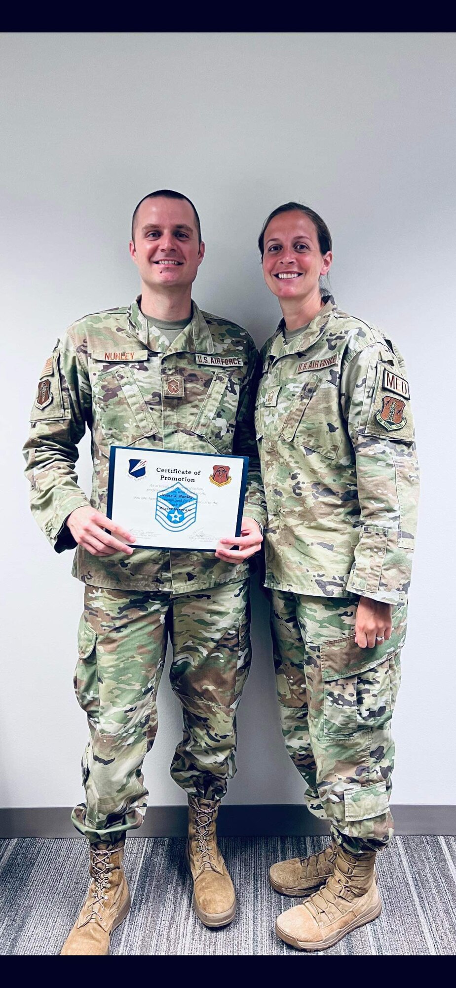 Missouri Air National Guard Master Sgts. Jessie Nunley and Kristen Nunley pose for a photo commemorating Jessie's promotion. Both Airmen serve in medical career fields in their military and civilian capacities. (Courtesy photo)