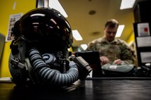 A pilot helmet lies on a counter