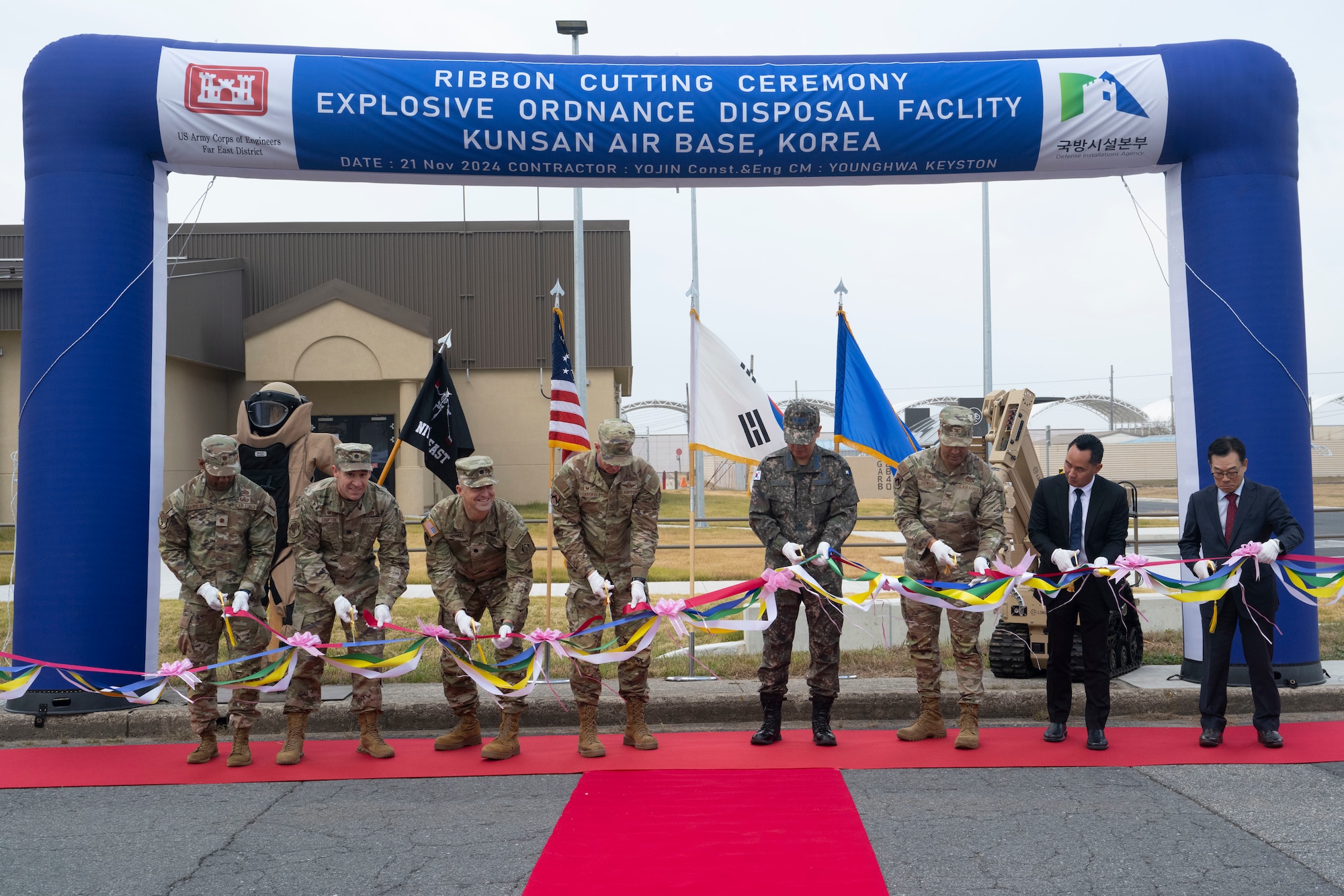 U.S. Air Force Col. Peter “Wolf” Kasarskis, center, 8th Fighter Wing commander, stands alongside base leadership and host nation military and civilian partners during the explosive ordnance disposal ribbon-cutting ceremony for a new facility.