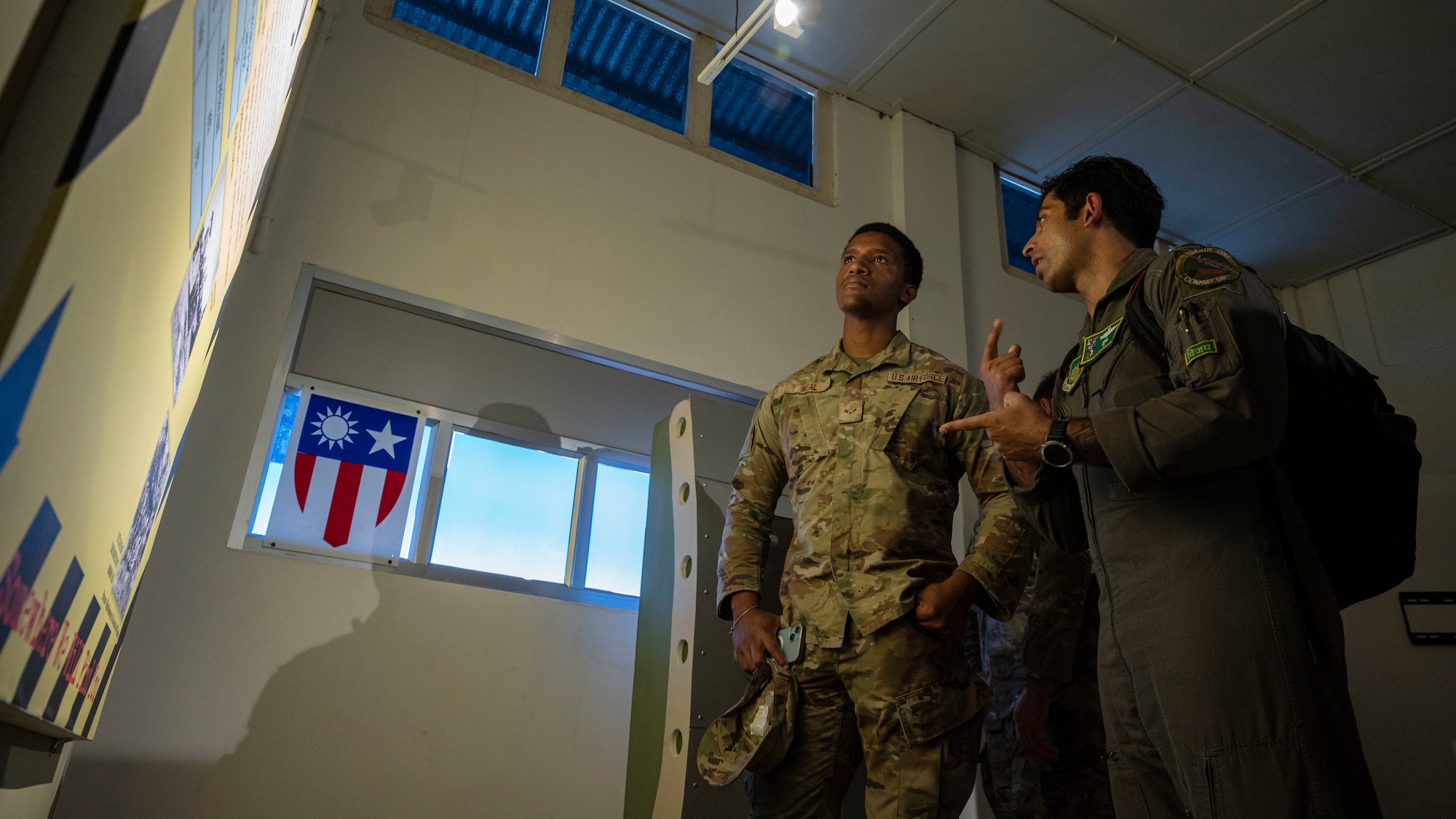 U.S. Air Force Capt. Niv Maramreddy, right, 25th Fighter Squadron pilot, and Senior Airman Deandre Black, 25th Fighter Generation Squadron crew chief, discuss the history of the 25th FS at Assam, India, Sept. 15, 2024. In January, 1982, the 25th FS received its first A-10 Thunderbolt II aircraft. A timeless partnership between the U.S. and India expands interoperability and ensures a safe, secure, and open Indo-Pacific. (U.S. Air Force photo by Senior Airman Sabrina Fuller-Judd)