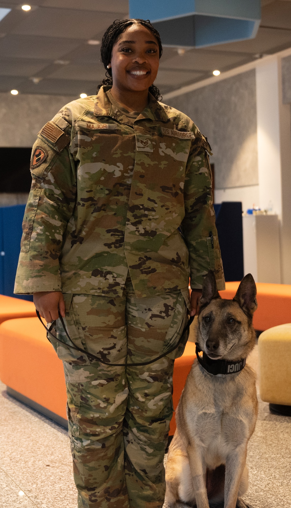 Woman poses with military working dog