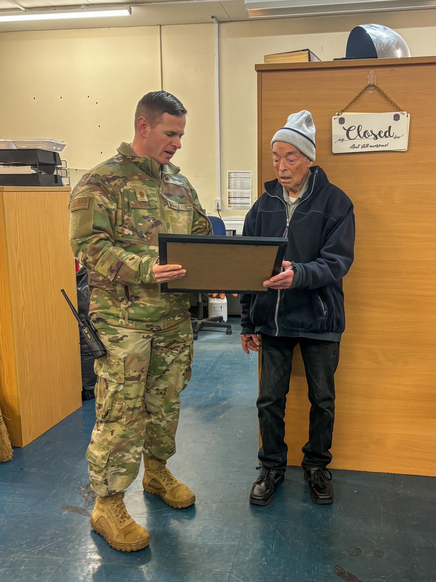 Mr. Simon Martin receives a gift from his squadron commander
