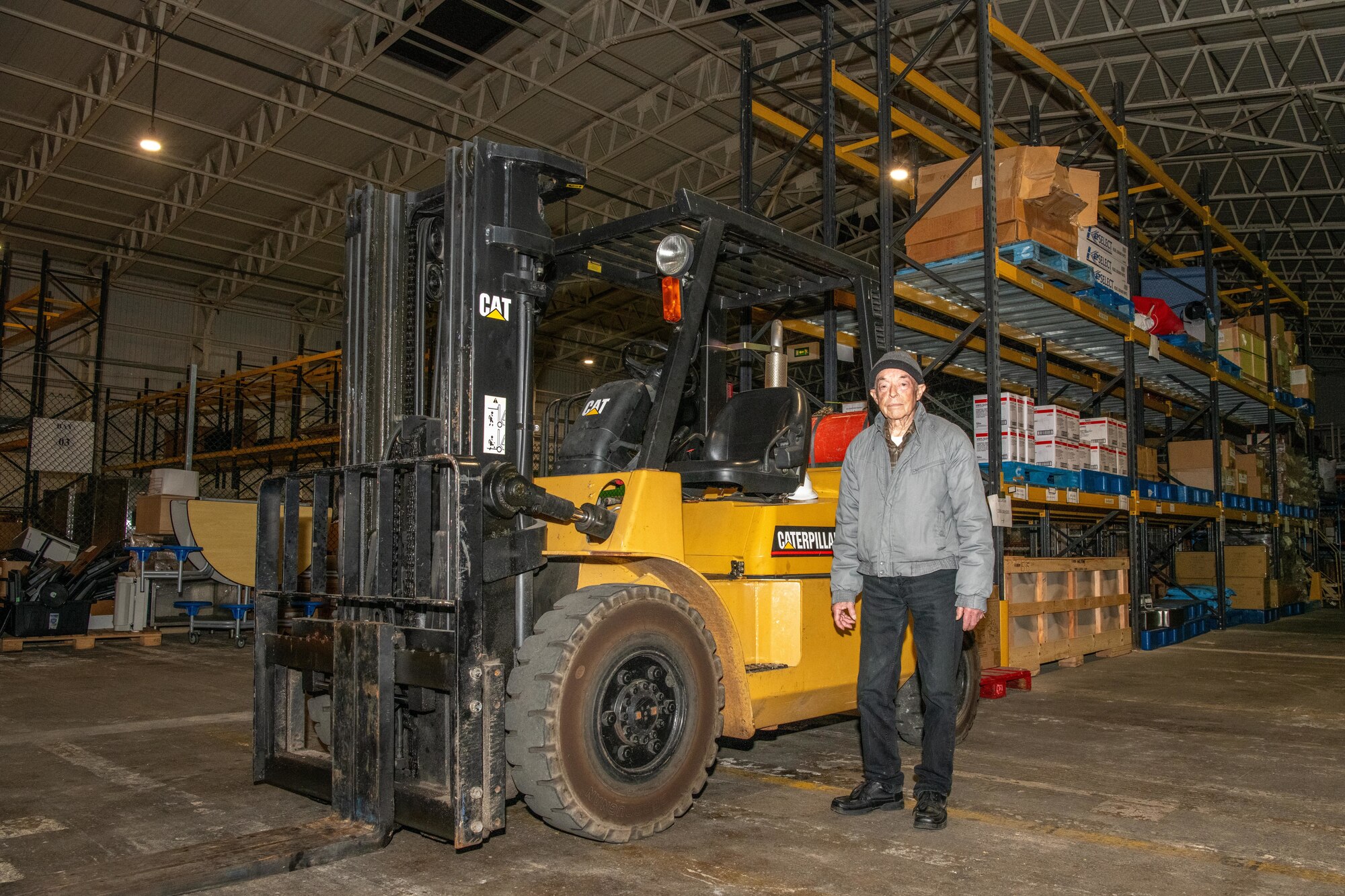 Mr. Simon Martin poses for a photo inside of the Croughton Consolidated Warehouse