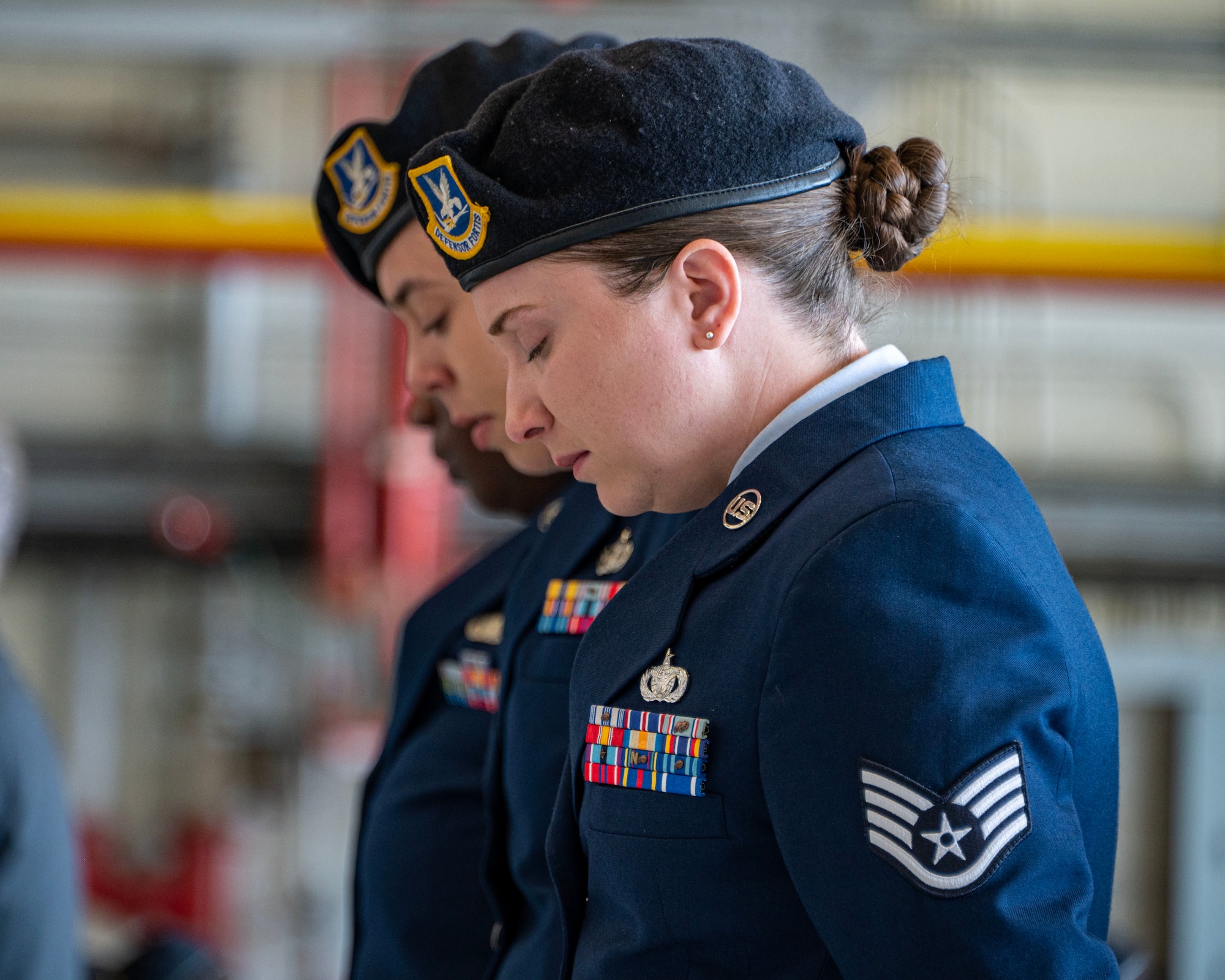 U.S. Air Force Staff Sgt. Ashlyn Carter, 316th Security Force Squadron flight sergeant, observes a moment of silence during the memorial service for Staff Sgt. Bailey Behzadi at Joint Base Andrews, Md., Oct. 21, 2024. Fellow defenders in the 316th SFS described Behzadi as a cornerstone of the unit, as he constantly checked in on others and advocated for change that would improve the team and the unit. (U.S. Air Force photo by Staff Sgt. Aubree Owens)