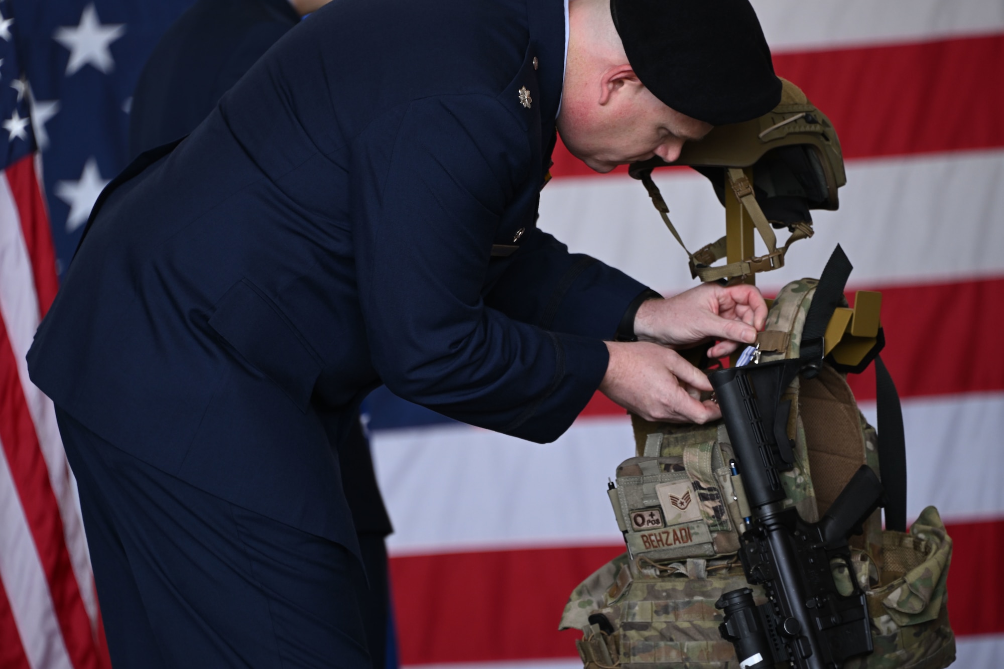 U.S. Air Force Lt. Col. Timothy Marriner, 316th Security Forces Squadron commander, pins a medal during the memorial service for Staff Sgt. Bailey Behzadi at Joint Base Andrews, Md., Oct. 21, 2024. Behzadi was recognized for his meritorious service as a base defense operations center controller, where his leadership and decisive actions ensured the security of critical assets. (U.S. Air Force photo by Airman 1st Class Gianluca Ciccopiedi)