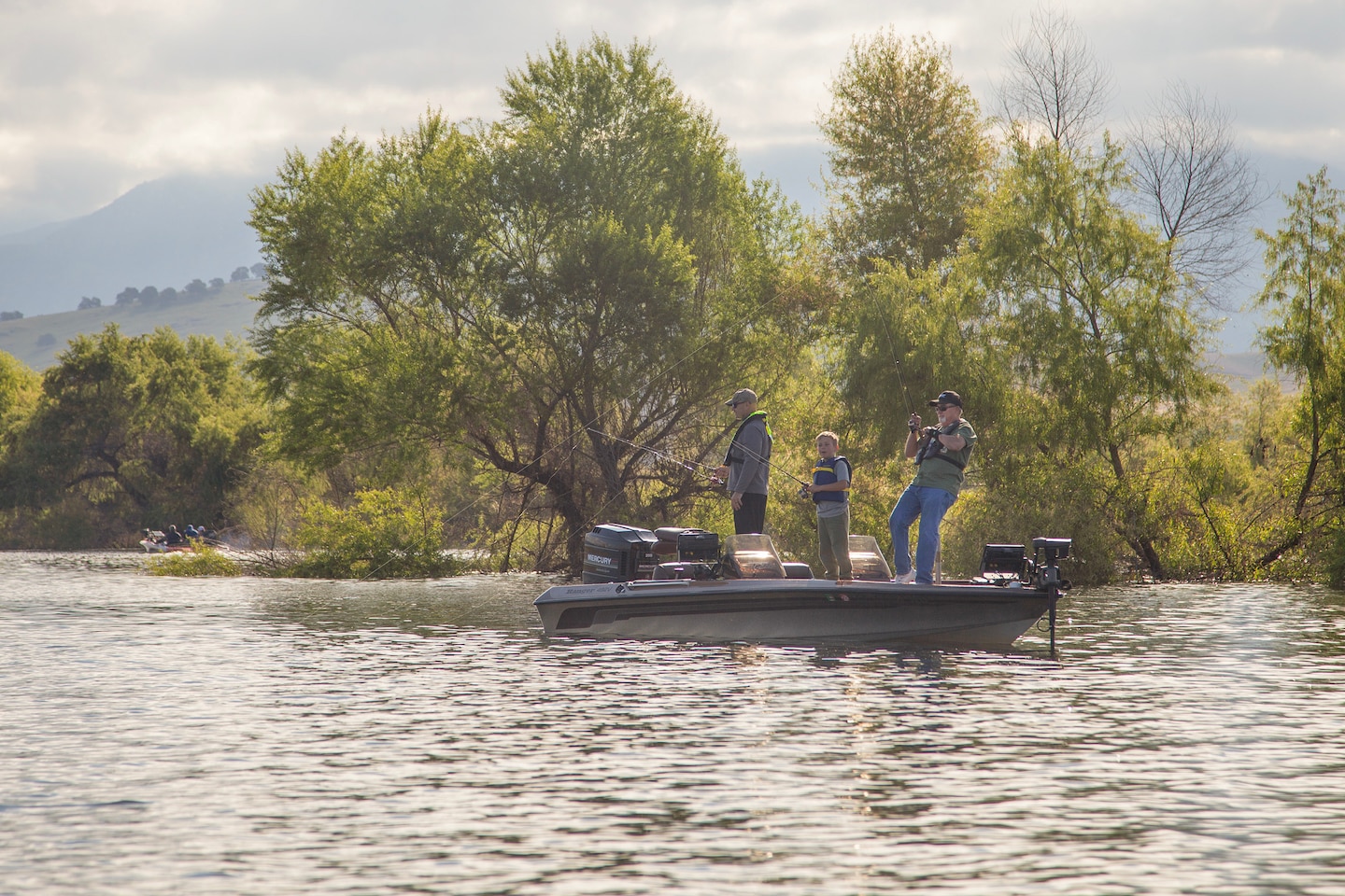Calvin Foster, joined by U.S. Army Corps of Engineers Sacramento District commander Col. Chad Caldwell, and Caldwell's son, fish for largemouth bass at Success Lake, California, April 27, 2024.