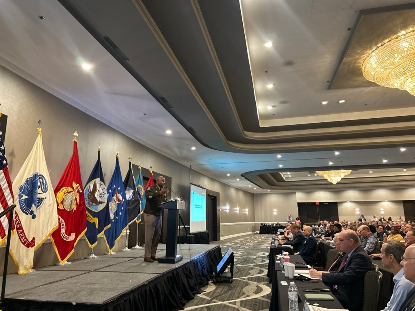 man in uniform speaks to audience
