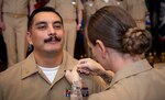 240927-N-KC192-1060 PORTSMOUTH, Va. (Sept. 27, 2024) Chief Hospital Corpsman (Select) Eric Garcia, assigned to Navy and Marine Corps Public Health Force Protection Command, is pinned to the rank of Chief Petty officer by his wife, Chief Hospital Corpsman (Select) Jessica Garcia, assigned to Navy Medicine Readiness and Training Command (NMRTC) Portsmouth, during  a chief pinning ceremony held on board Naval Support Activity (NSA) Hampton Roads - Portsmouth Annex, Sept. 27, 2024. During the ceremony, key speakers imparted the importance of resiliency and how deckplate leaders can better foster a positive environment for their Sailors to succeed. (U.S. Navy photo by Mass Communication Specialist 2nd Class Levi Decker)
