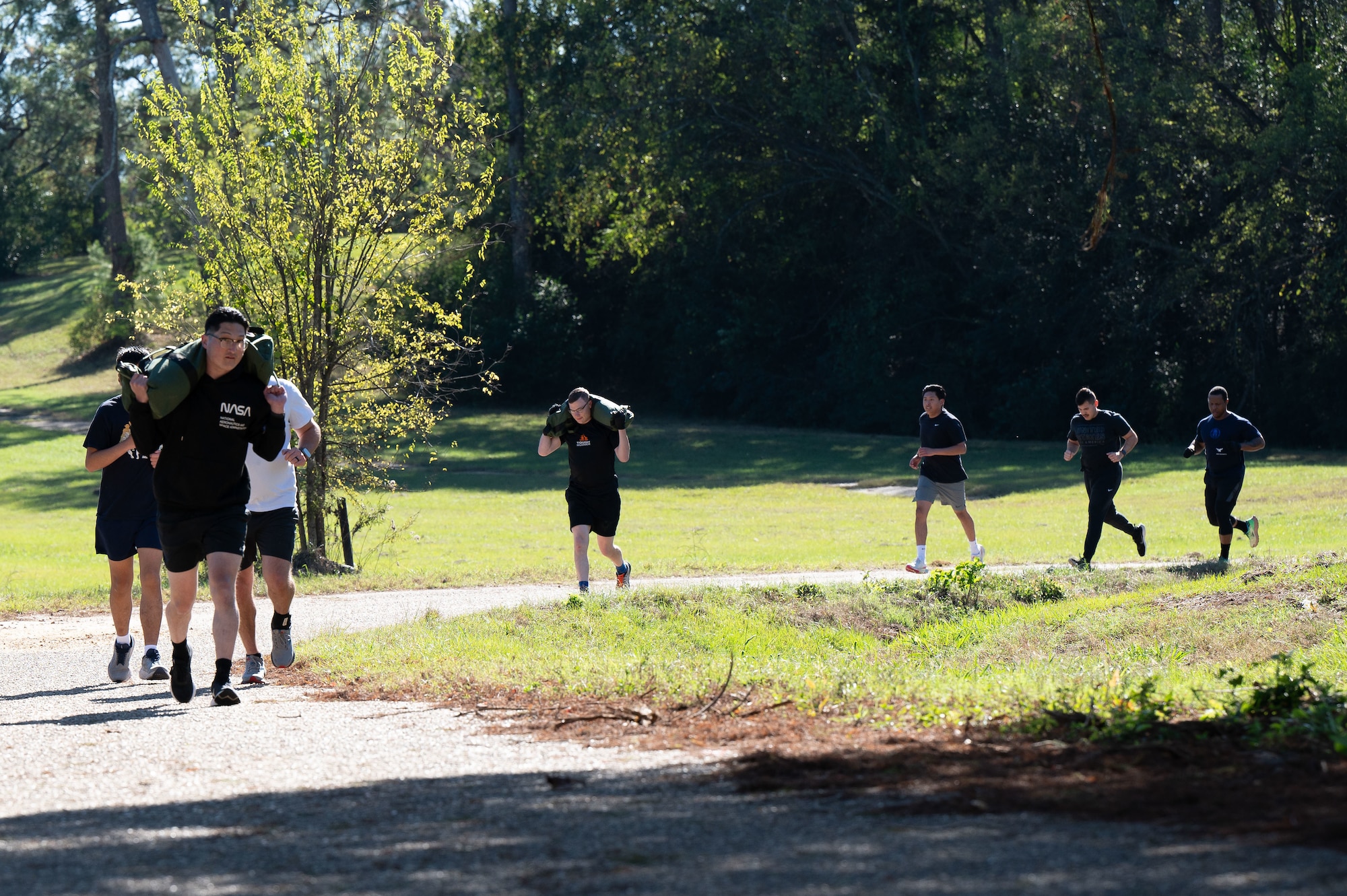 U.S. Airmen run in a mile-long Warrior Race during GRIT Week at Maxwell Air Force Base, Ala, Nov. 21, 2024. Teams ran a mile and completed collective tasks such as 200 push-ups, 400 squats, water balloon volleyball, and a balloon-shaving team challenge.