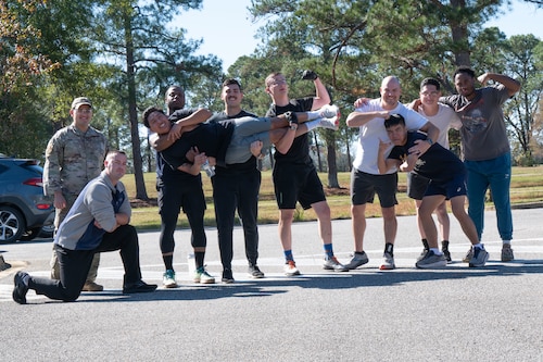 U.S. Airmen pose for a group photo after finishing the GRIT Week Warrior Race at Maxwell Air Force Base, Ala, Nov. 21, 2024. GRIT Week is an annual, week-long event featuring a variety of activities to foster resilience and teamwork.