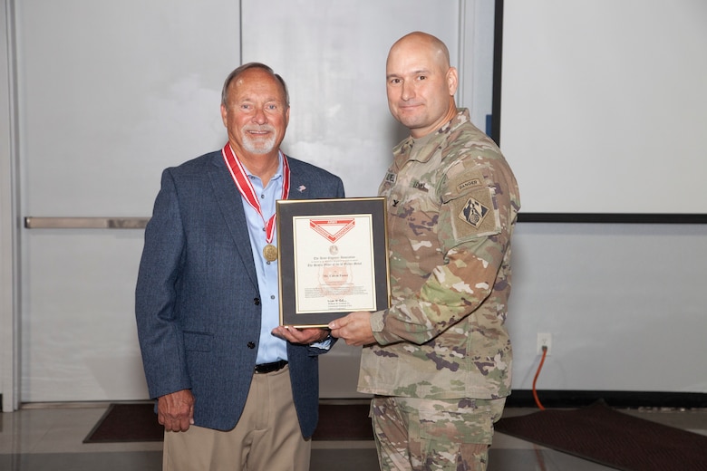 Col. Chad Caldwell presents the U.S. Army Corps of Engineers Bronze de Fleury Medal to Calvin Foster upon his retirement.