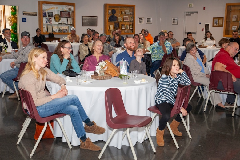 Friends and family members look on as Calvin Foster is honored during his retirement luncheon.