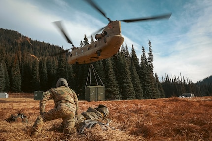 U.S. Soldiers with 1st Battalion, 168th Aviation Regiment (General Support Aviation Battalion), Washington National Guard, attach a cargo hook to a CH-47 Chinook during sling-load operations near Mount Rainier, Wash., Oct. 25, 2024. Washington National Guard aviation assets were activated Oct. 25-27 to support the U.S. Navy in its recovery of an EA-18G Growler fighter jet.