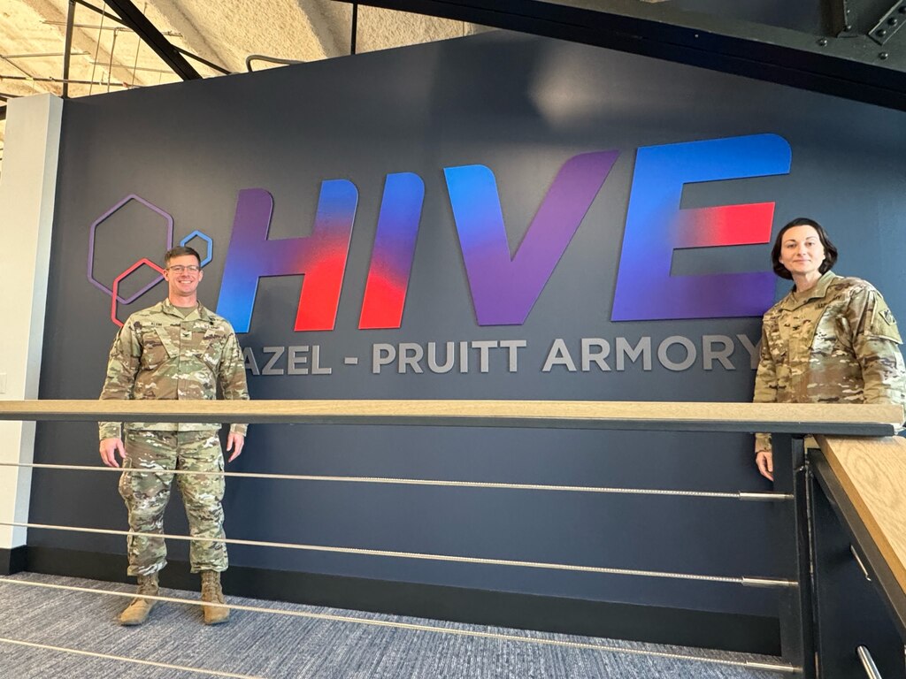 Col. Klein and Col. Haupt on either side of a sign saying HIVE