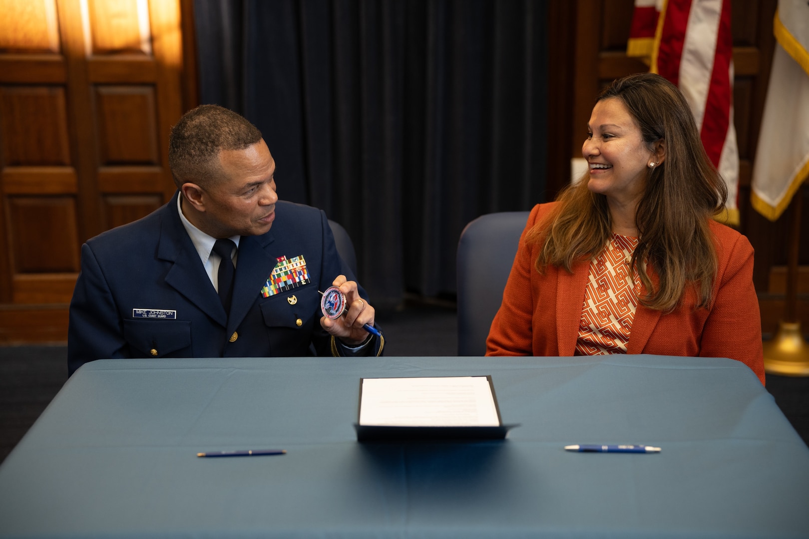 U.S. Coast Guard Rear Adm. Mike Johnston, Superintendent of the U.S. Coast Guard Academy, and Jennifer Ferat sign an agreement as part of the Academy’s role in hosting the Military Operations Research Society (MORS) 93rd Symposium, Nov 18, 2024. Approximately 1,000 defense experts from government, academia, and industry will gather to address critical national security challenges. (U.S. Coast Guard photo by Petty Officer 3rd Class Matt Thieme)