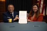 U.S. Coast Guard Rear Adm. Mike Johnston, Superintendent of the U.S. Coast Guard Academy, and Jennifer Ferat sign an agreement as part of the Academy’s role in hosting the Military Operations Research Society (MORS) 93rd Symposium, Nov 18, 2024. Approximately 1,000 defense experts from government, academia, and industry will gather to address critical national security challenges. (U.S. Coast Guard photo by Petty Officer 3rd Class Matt Thieme)