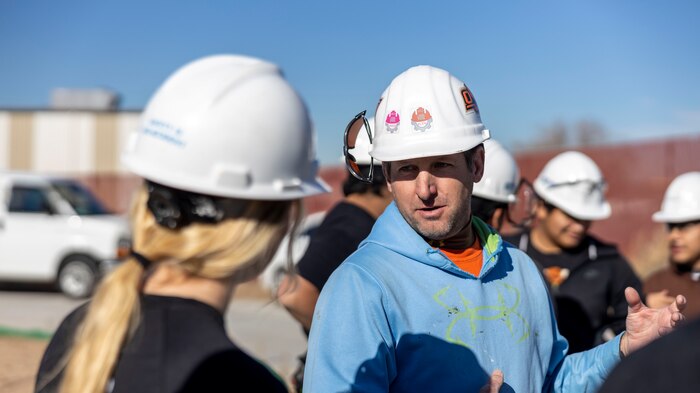 Mr. Matt Webber, a construction teacher with District 6 Career and Technical Education, speaks with U.S. Marine Corps Staff Sgt. Christa Brown, staff noncommissioned officer of Recruiting Sub-Station Fort Collins, in Greeley, Colo., Nov. 15, 2024. Marines with RSS Fort Collins volunteered with Habitat for Humanity to help build homes, showcasing their dedication to giving back and supporting the local community. (U.S. Marine Corps photo by Sgt. Jackson Ricker)