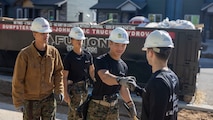 U.S. Marines with Recruiting Sub-Station Fort Collins share a moment of camaraderie in Greeley, Colo., Nov. 15, 2024. Marines with RSS Fort Collins volunteered with Habitat for Humanity to help build homes, showcasing their dedication to giving back and supporting the local community. (U.S. Marine Corps photo by Sgt. Jackson Ricker)