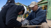U.S. Marine Corps Staff Sgt. Keith Foster, a recruiter with Recruiting Sub-Station Fort Collins, prepares to trim lumber with a volunteer in Greeley, Colo., Nov. 15, 2024. Marines with RSS Fort Collins volunteered with Habitat for Humanity to help build homes, showcasing their dedication to giving back and supporting the local community. (U.S. Marine Corps photo by Sgt. Jackson Ricker)