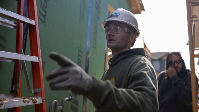 U.S. Marine Corps Staff Sgt. Brandon Michauld, a recruiter with Recruiting Sub-Station Fort Collins, directs volunteers in Greeley, Colo., Nov. 15, 2024. Marines with RSS Fort Collins volunteered with Habitat for Humanity to help build homes, showcasing their dedication to giving back and supporting the local community. (U.S. Marine Corps photo by Sgt. Jackson Ricker)