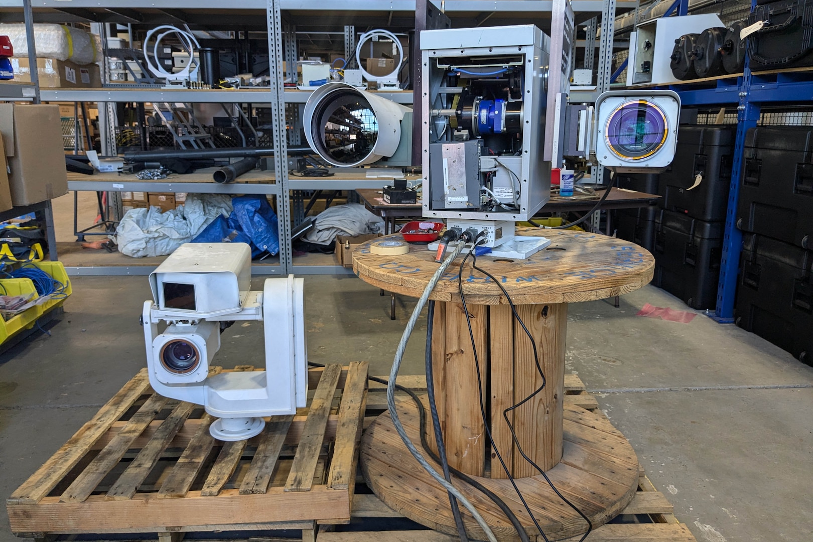Two cameras are displayed in a warehouse.