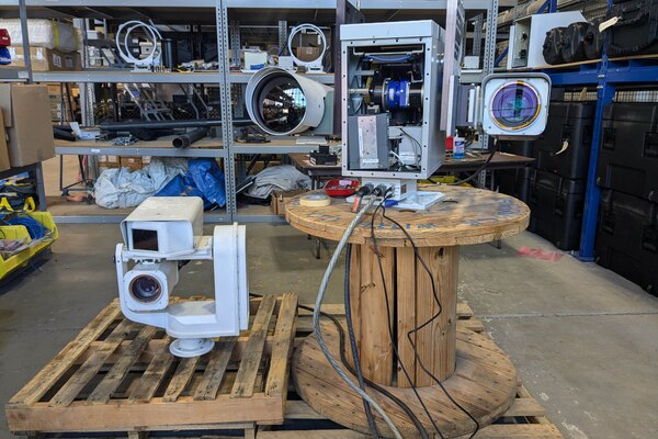 Two cameras are displayed in a warehouse.