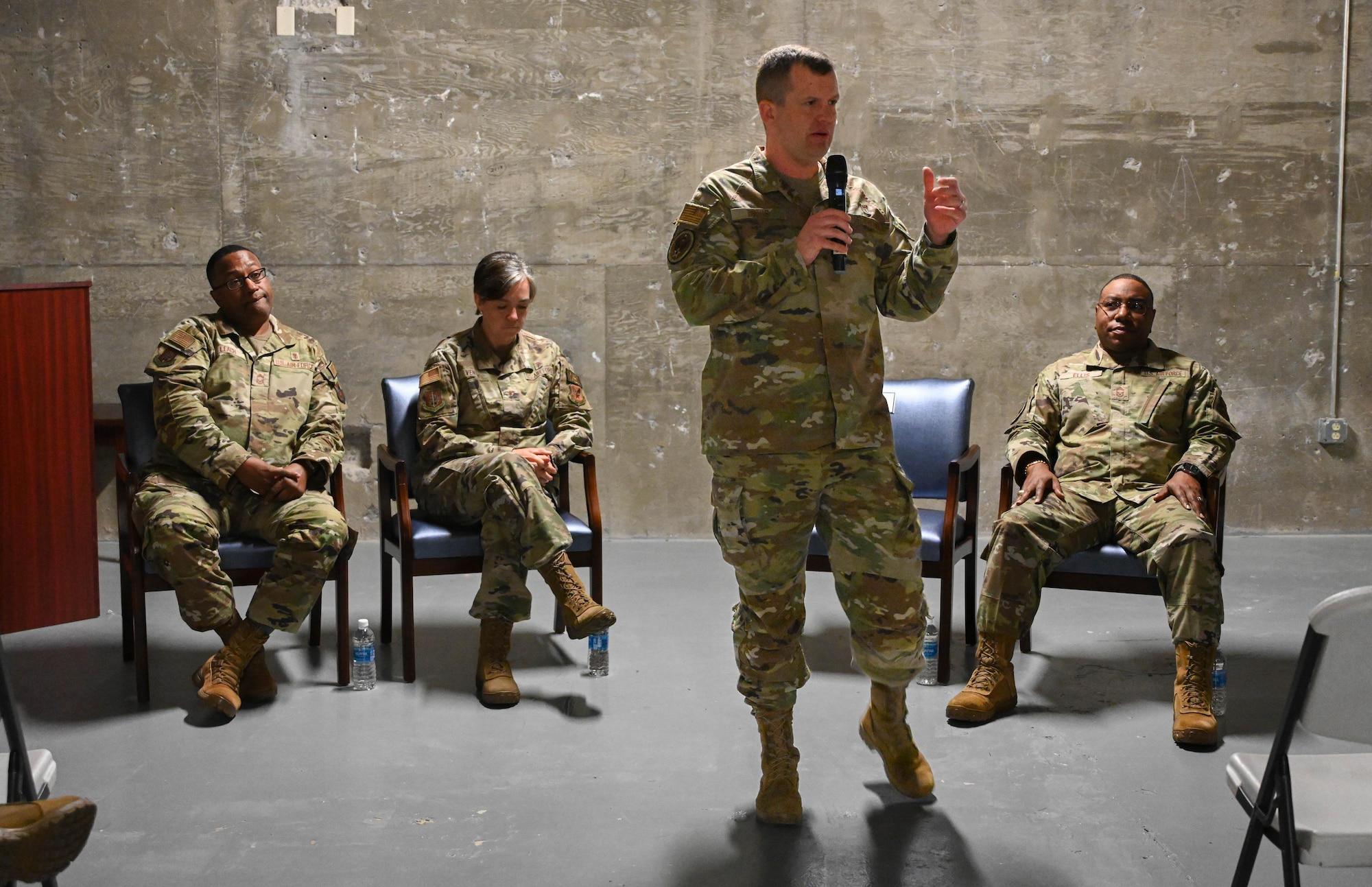 U.S. Air Force Col. John Davis, Air Education and Training Command command surgeon, speaks during a 97th Medical Group all-call at Altus Air Force Base, Oklahoma, Nov. 20, 2024. During the discussion, Airmen were given the opportunity to ask questions regarding the future of medical care in the Air Force. (U.S. Air Force photo by Senior Airman Miyah Gray)